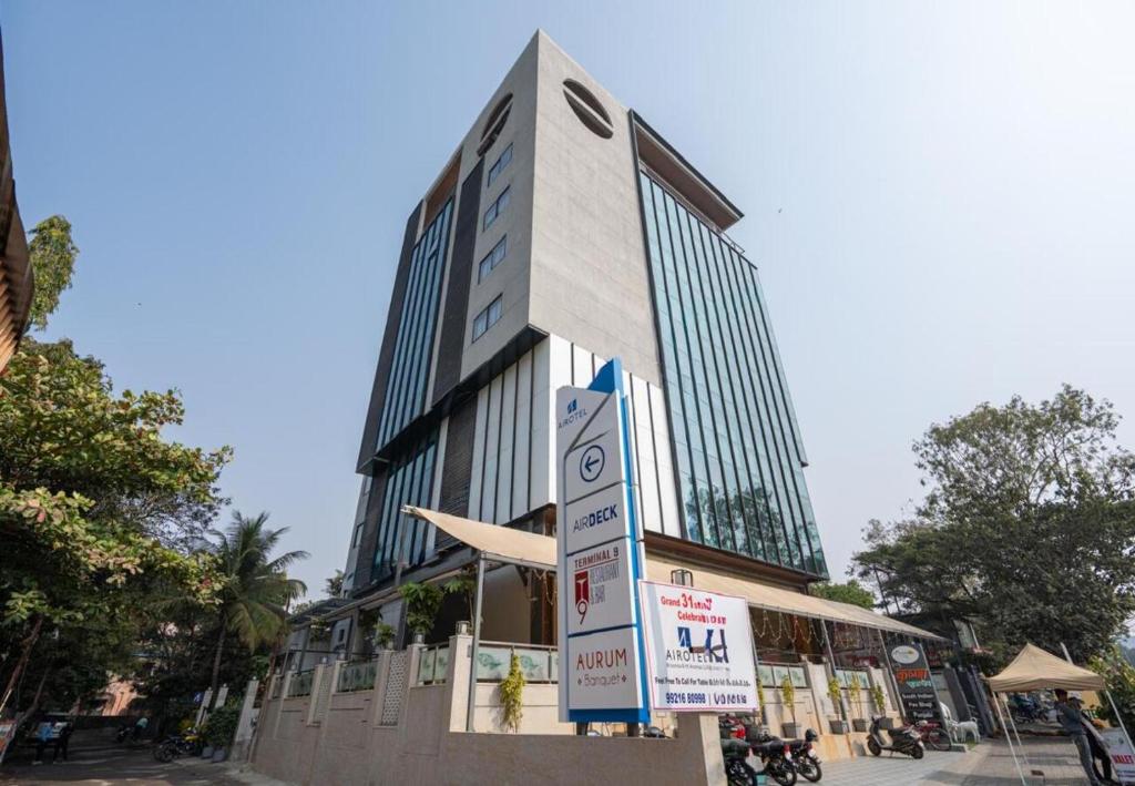 a tall building with signs in front of it at Airotel in Pune