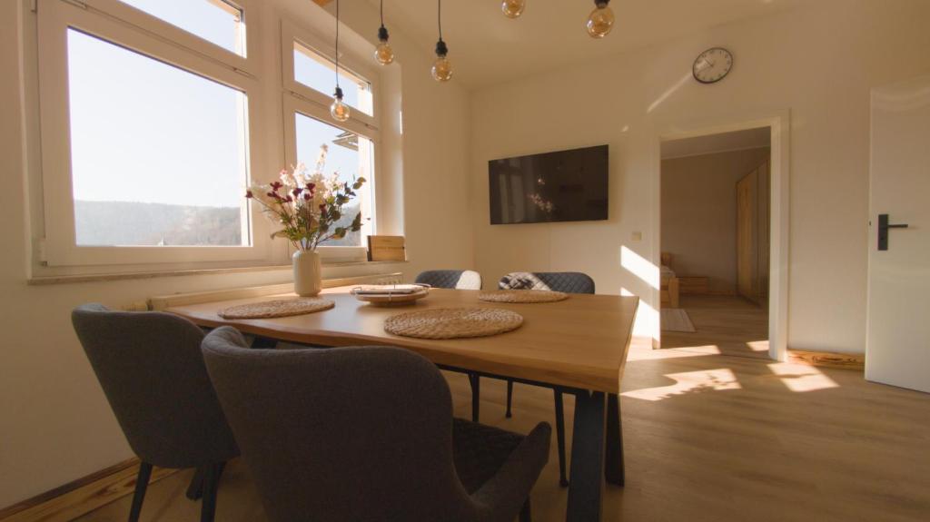 a dining room with a wooden table and chairs at Ferienwohnung Stadtblick Königstein in Königstein an der Elbe