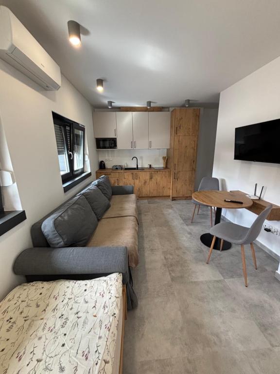 a living room with a couch and a table at Nocleg Szwed-Pol in Jastrowie