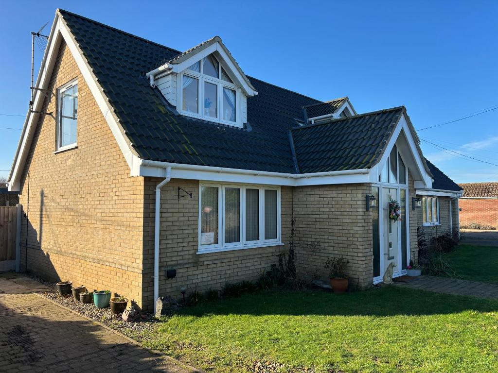 a brown brick house with a black roof at Seaview in Lowestoft