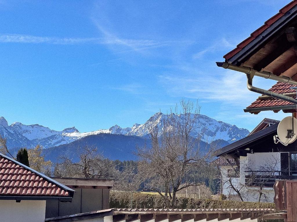 a view of snowy mountains from a house at Ferienwohnen beim Hirsch in Hopferau