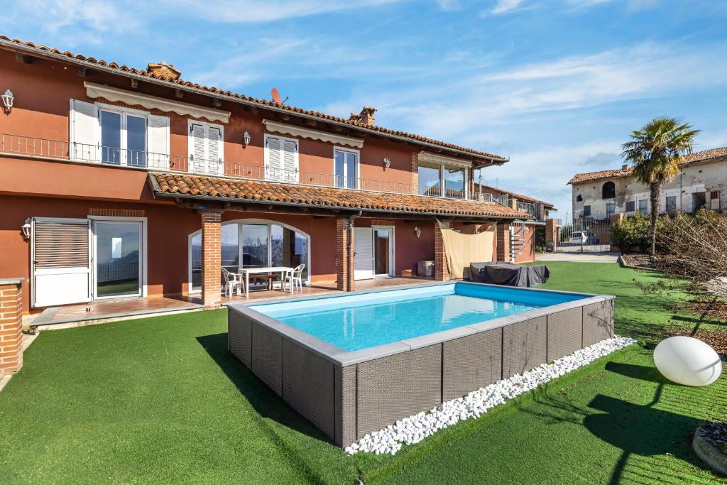 a house with a swimming pool in a yard at Hostdomus - Residenza La Vigna in Dogliani