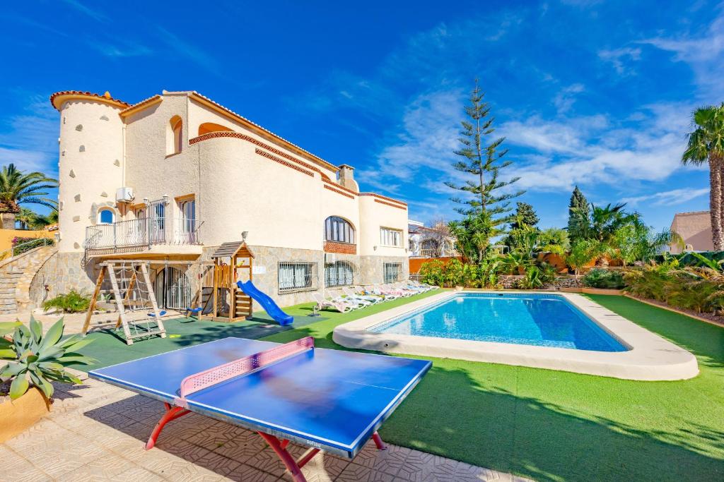 a villa with a swimming pool and a house at Villa Cronos - PlusHolidays in Ifach