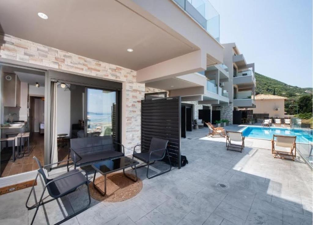 a house with a swimming pool and a patio at 3 Keys Luxury Apartment in Nikiana