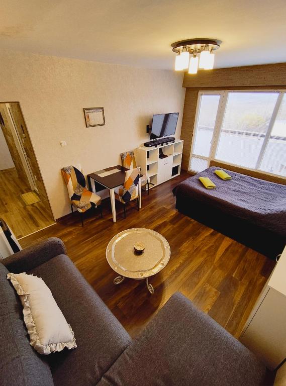 a living room with a bed and a couch at Студио Странджа - Граматиково in Gramatikovo