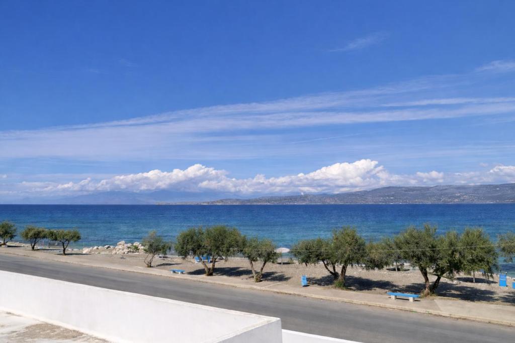 a view of the ocean and a road at Beachfront Absolute Bliss in Perigiali, Korinthia in Periyiálion