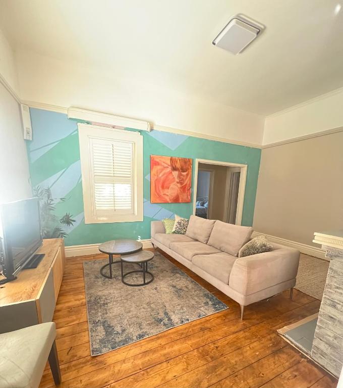 a living room with a couch and a table at Seaside Sanctuary in Aspendale