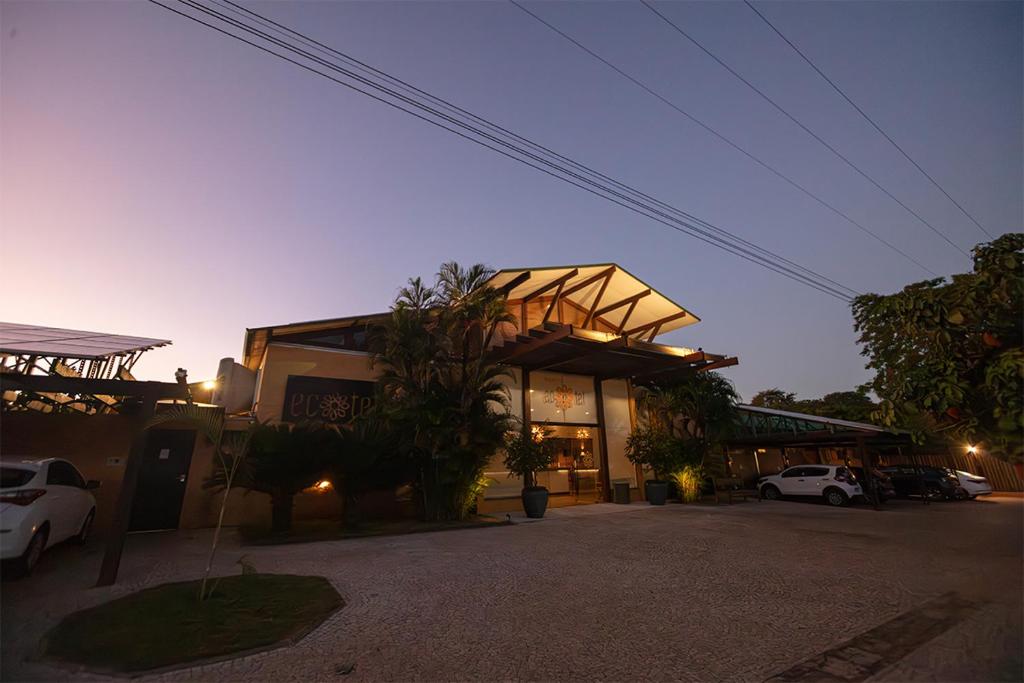 a building with cars parked in a parking lot at Bonito Ecotel in Bonito