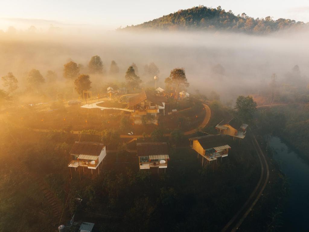 an aerial view of a village in the fog at Chang'E Villa Rakthai in Ban Rak Thai
