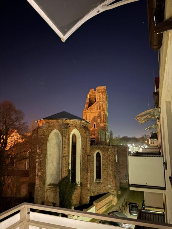 an old church at night with the sky at SWP Plac Solny 4 z klimatyzacją in Głogów