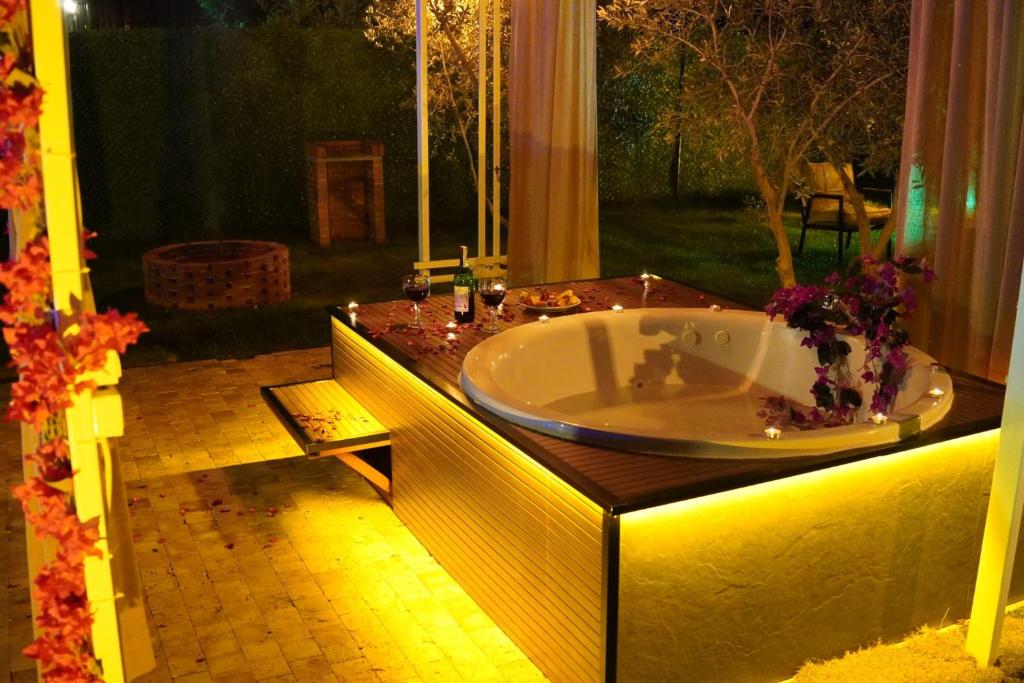 a bathroom with a bath tub in a yard at ON2 Bungalov Villas 2 in Antalya