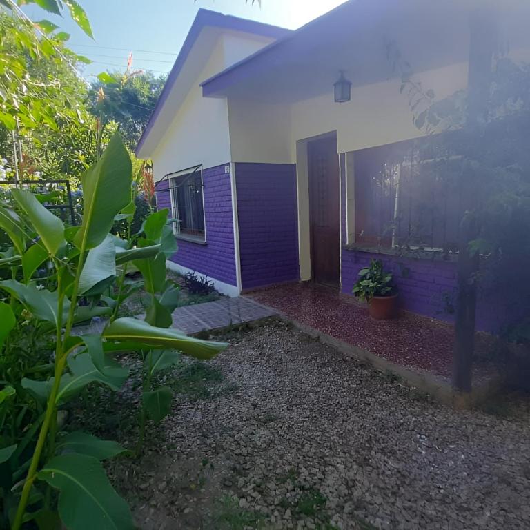 a house with purple paint on the side of it at casitadearminda in Villa Las Rosas