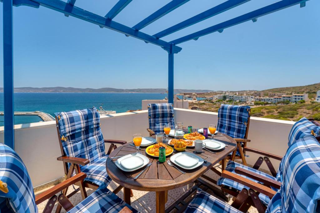 a table on the balcony with a view of the ocean at The Marina View in Lavrio