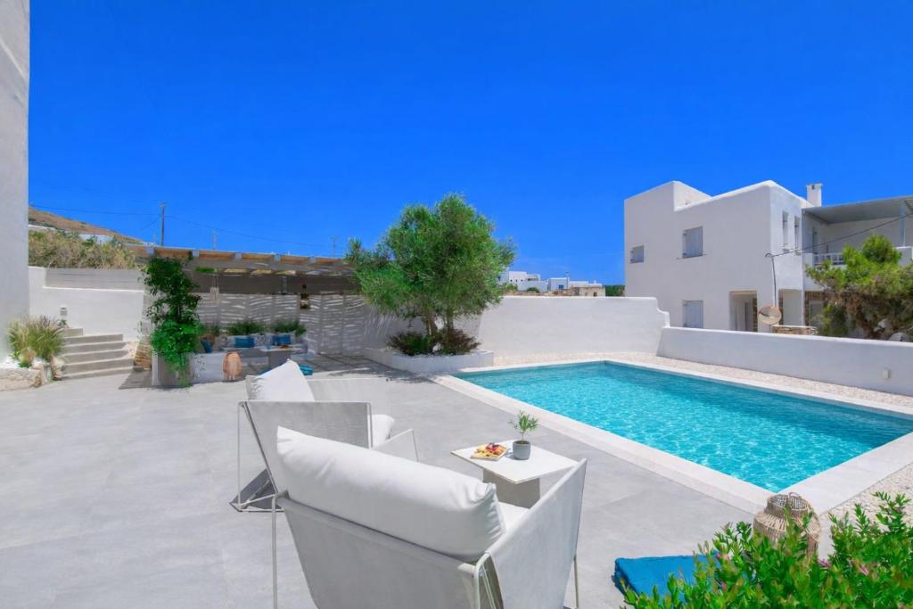 a villa with a swimming pool and a white at Alexander Suites in Drios