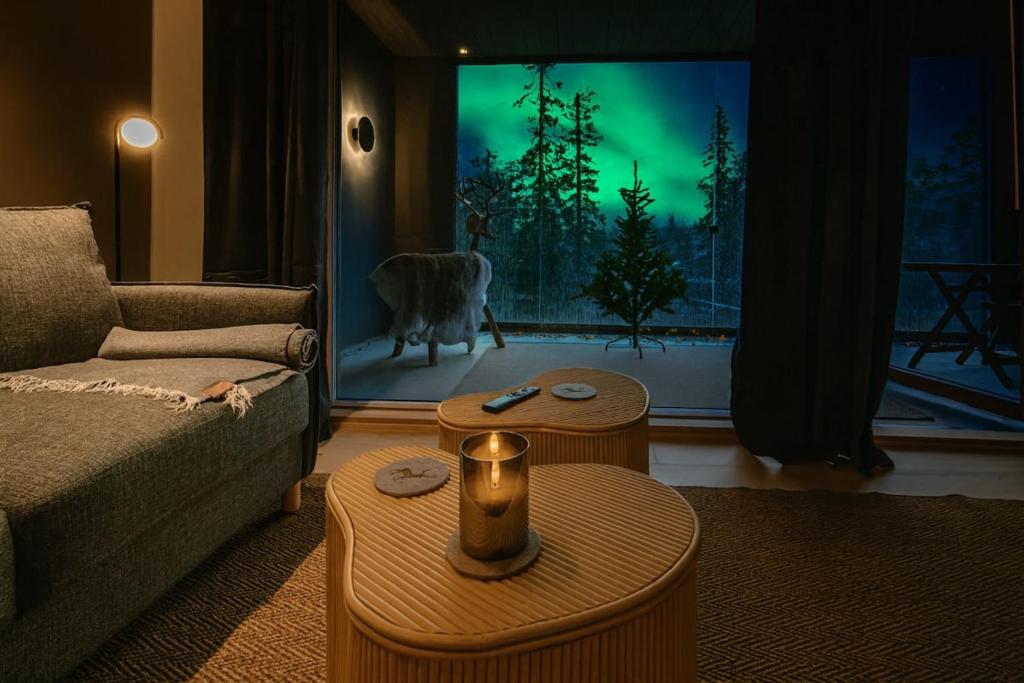 a living room with a couch and a dog in a window at Gielas Joiku Chalet - Ski-in Ski-out - Mountain View - incl 2 ski passes in Kittilä
