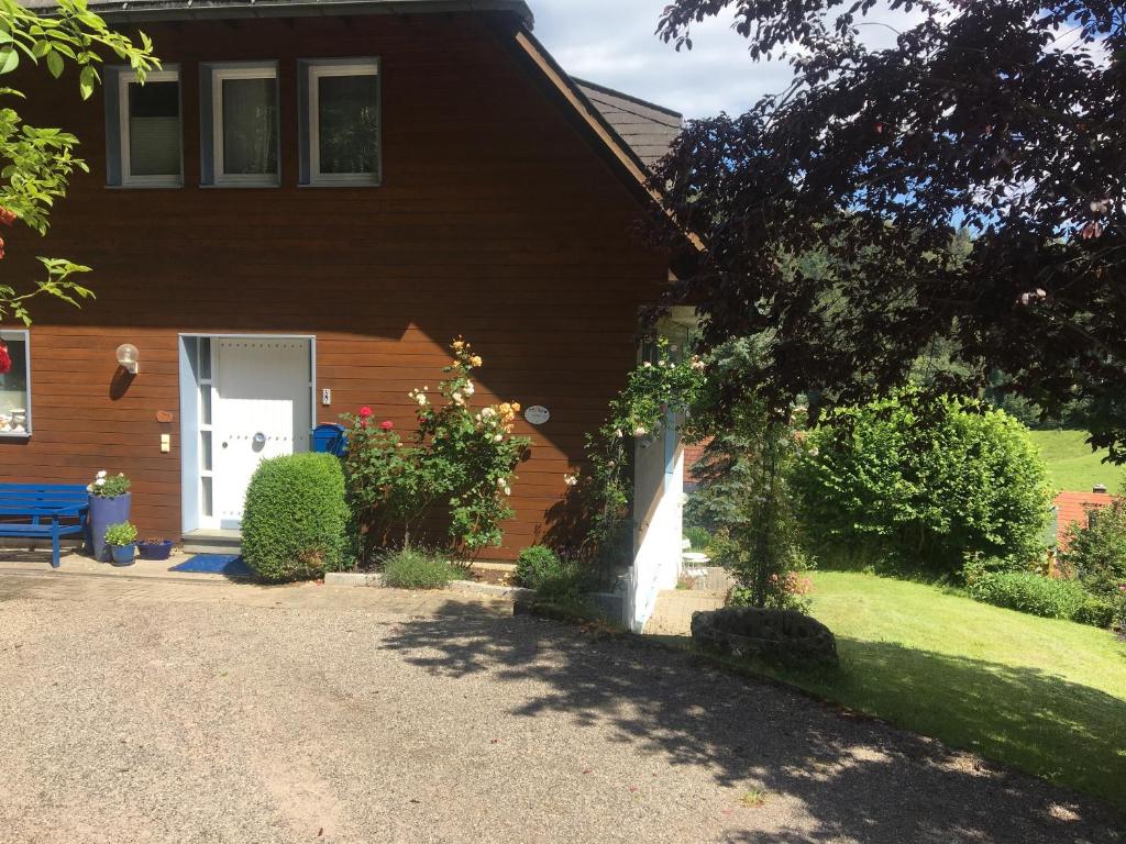 a house with a blue bench in front of it at Ferienhaus Rotzinger in Hinterzarten