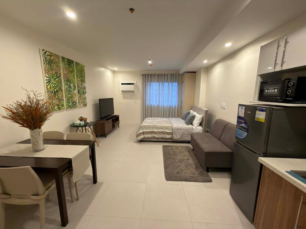 a living room with a couch and a bed at Matina enclaves condo studio type 6thfloor in Davao City