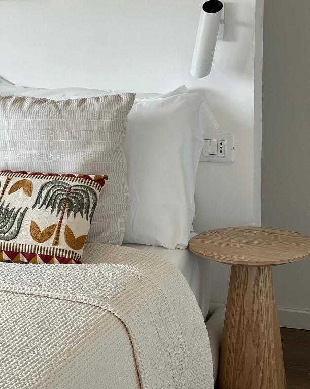 a bedroom with a bed with a wooden table at Casa MauRo in Senigallia
