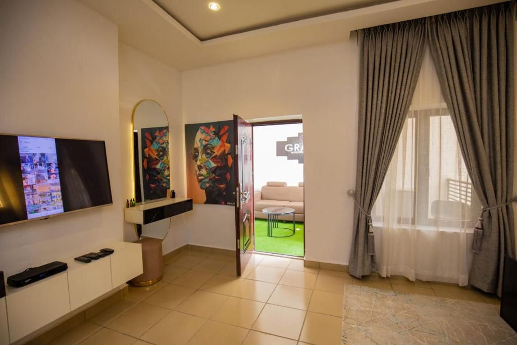 a living room with a television and a mirror at The Kitchen Kabinet in Abuja