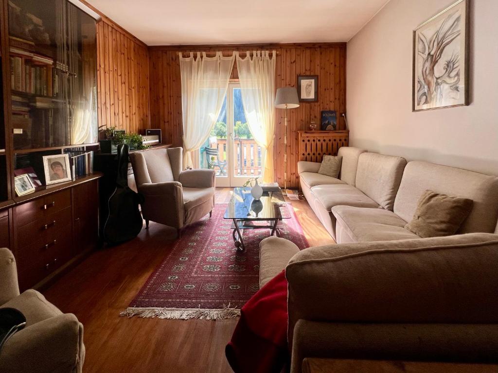 a living room with a couch and chairs and a table at Ceda Ladina in Santo Stefano di Cadore