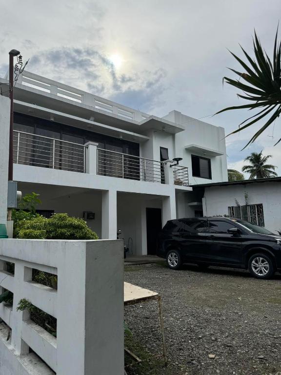 a black car parked in front of a house at casita de flocerfida in Boac