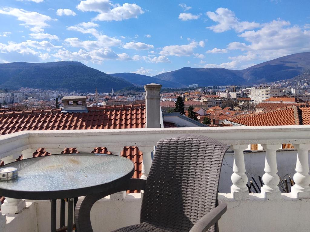 a table and chairs on a balcony with a view at Guest House LEA in Mostar