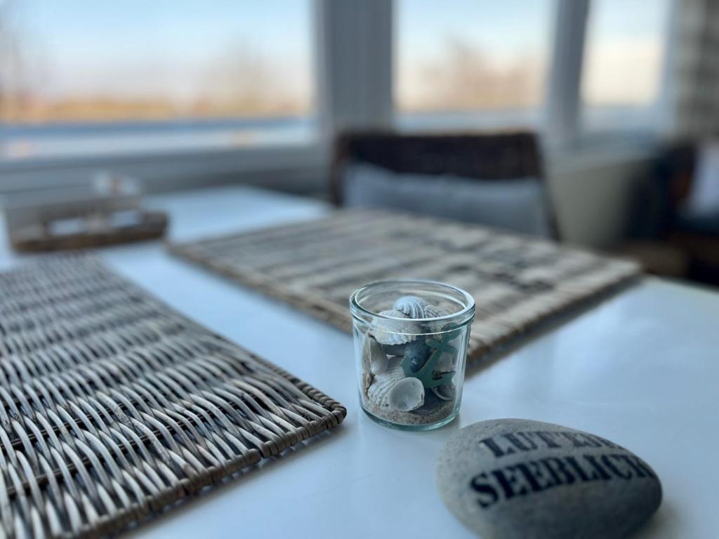 a table with a glass on top of a table at lüttjeseeblick13 in Nordstrand