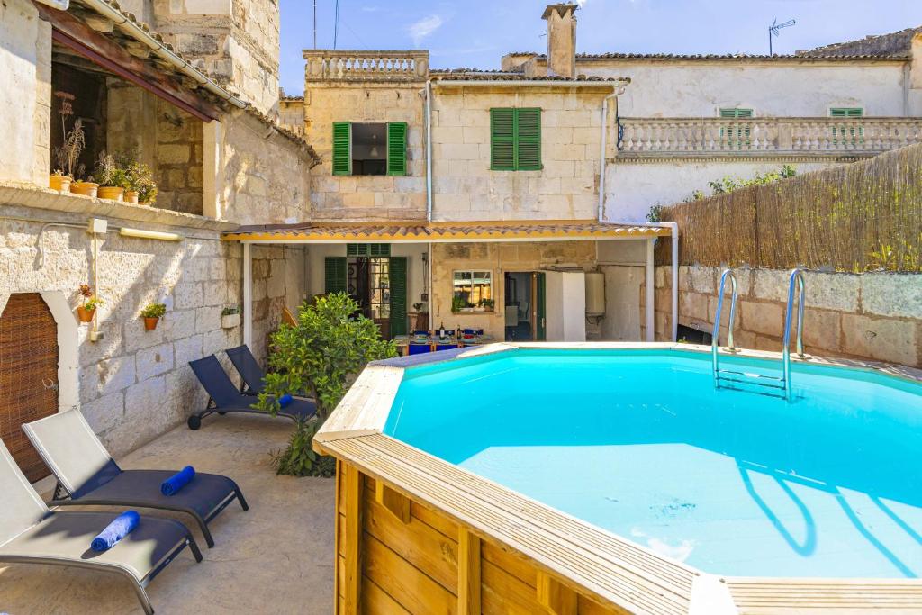 a swimming pool in the backyard of a house at Casa de Can Virolla Gran in Sa Pobla