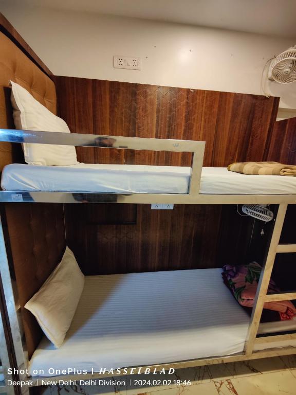 a couple of bunk beds in a room at The Charlie Backpackers in New Delhi
