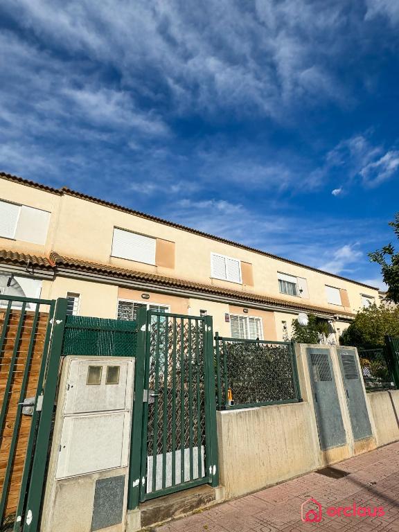 a green gate in front of a building at El Embarcadero in Oropesa del Mar