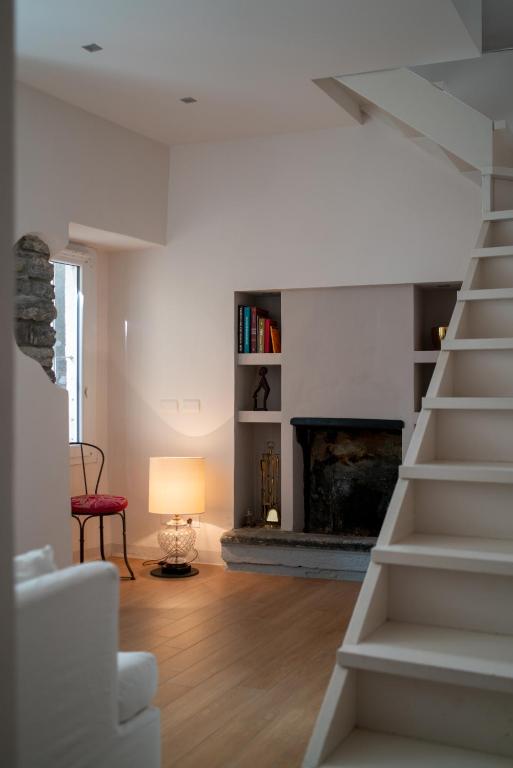 a living room with a staircase and a fireplace at Luxury Apartment in Moltrasio Center in Moltrasio
