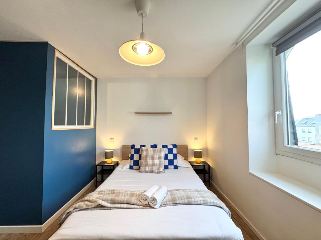 a bedroom with a bed with blue walls and a window at Chez Jacob, Centre de Rennes in Rennes