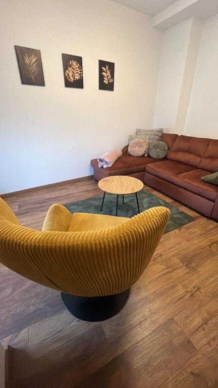 a living room with a couch and a chair at Apartament w Centrum - Parking in Ostrów Wielkopolski