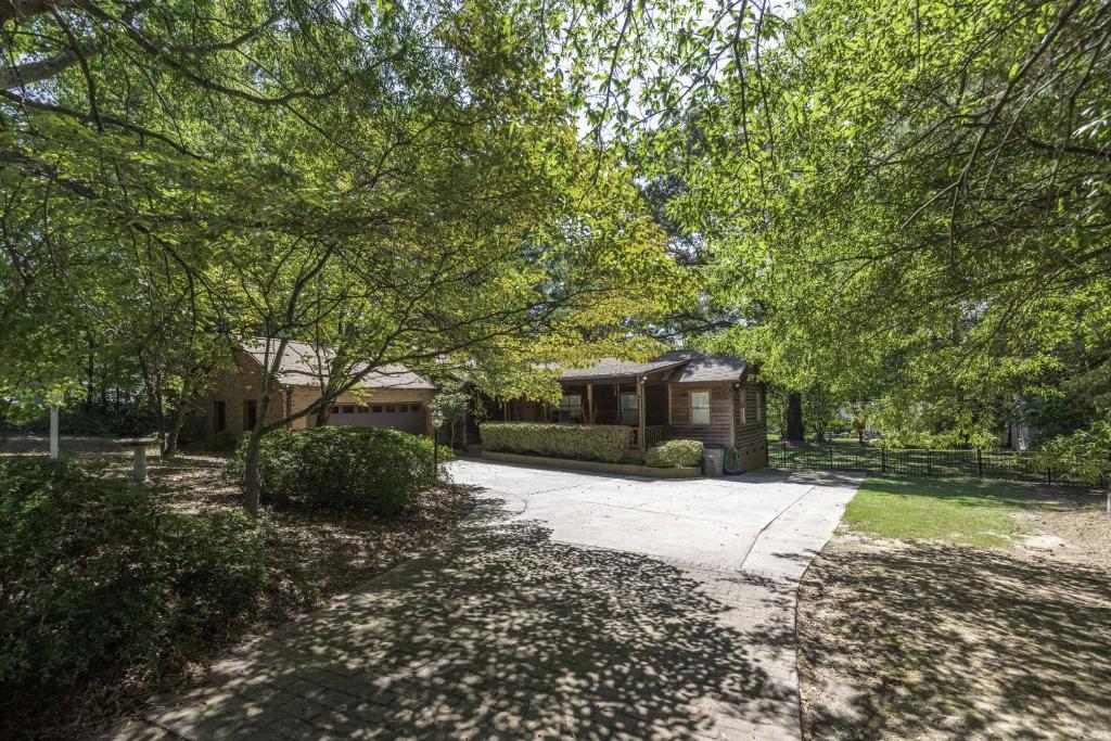 a home with a driveway leading to a house at Peaceful Kannapolis Lodge in Kannapolis