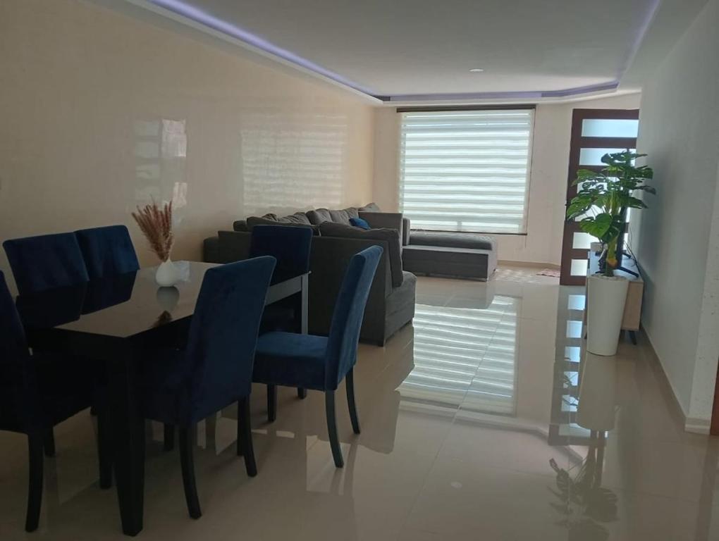 a living room with a table and a couch at Modern and Cozy Home in Acayuca