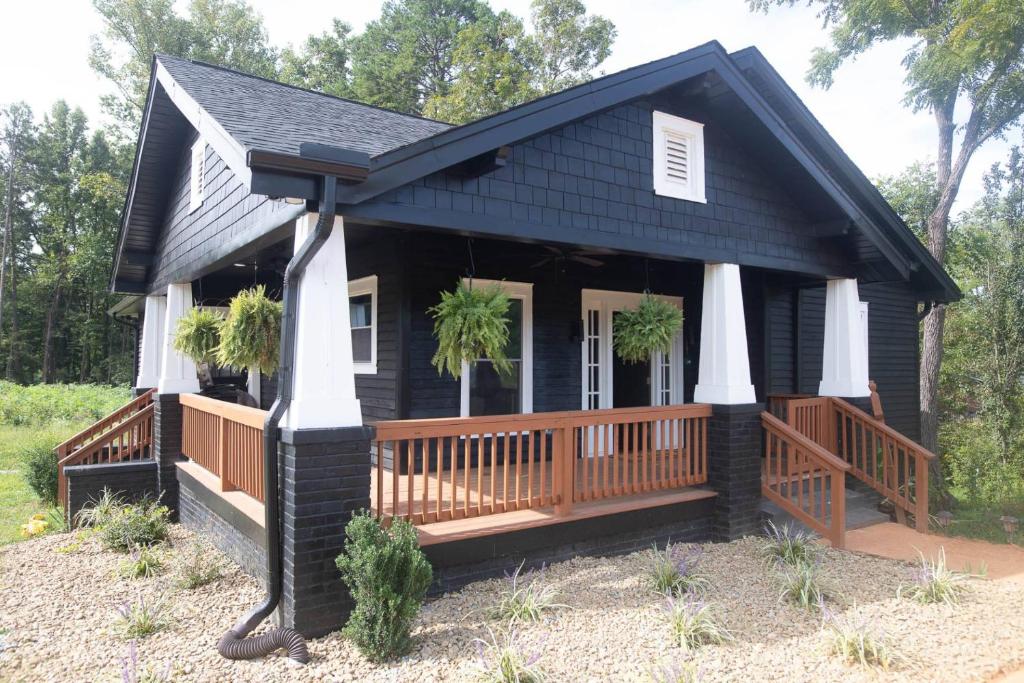a black house with a porch and a deck at ASecondU Peaceful Retreat in Salisbury