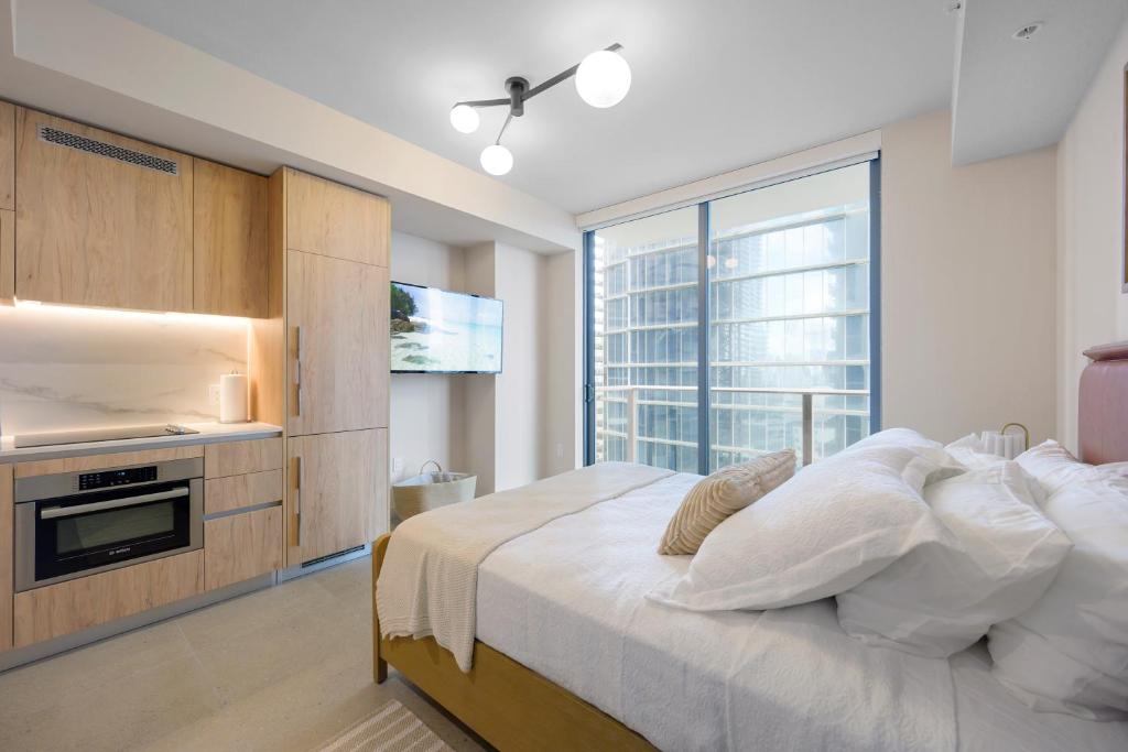 a bedroom with a bed and a large window at Prime Location Studio Steps from Top Attractions in Miami