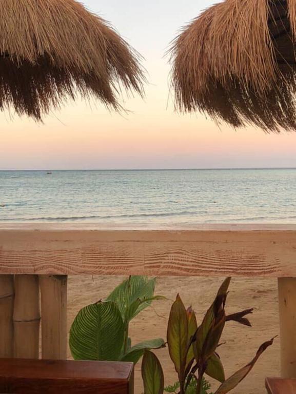 a view of the beach with a bench and the ocean at Downtown Keys in Hurghada