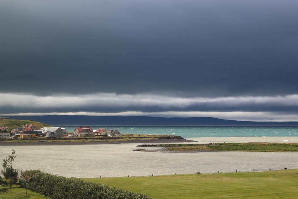 a large body of water with houses in the background at Gistiheimilið Ósbær in Blönduós