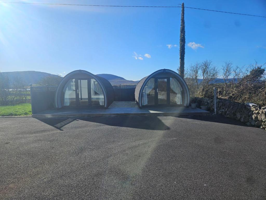a house with two domes on the side of a road at Silver Valley Glamping in New Quay