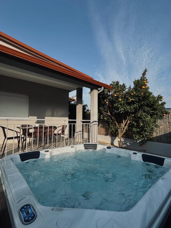 a hot tub in the backyard of a house at Zouf House Luxury Stay with Jacuzzi in Panayía Mesosporítissa