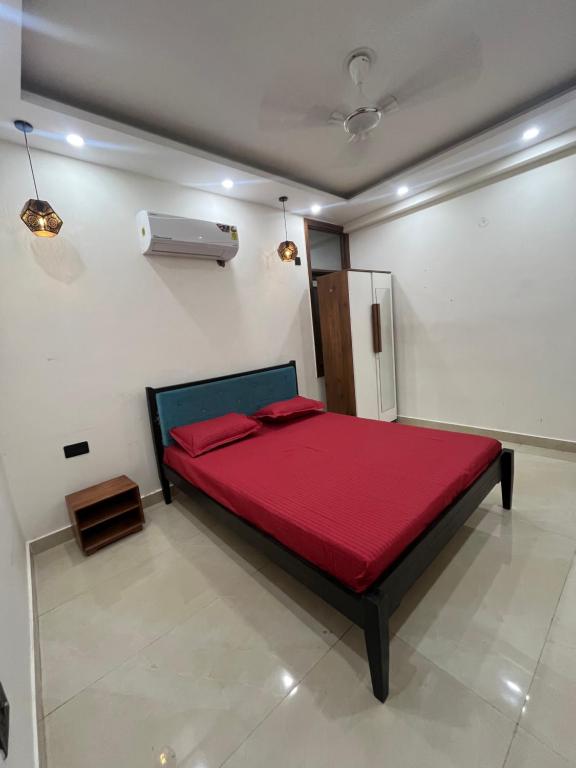a bedroom with a red bed in a room at 3BHK Independent Floor in New Delhi