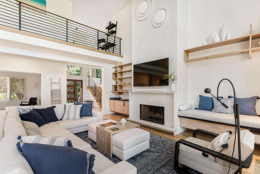 a living room with a white couch and a fireplace at 217 Glen Abbey in Kiawah Island