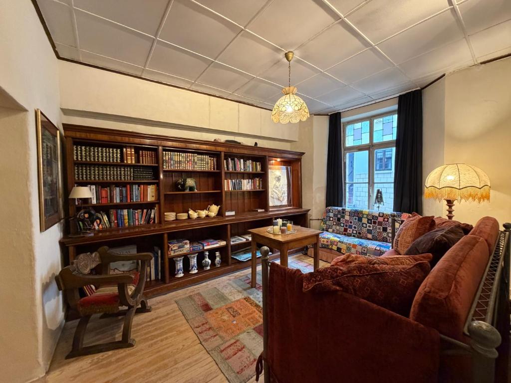 a living room with a couch and a table at Our Hippie Castle Vianden - Unique Bohemian Guesthouse in Vianden