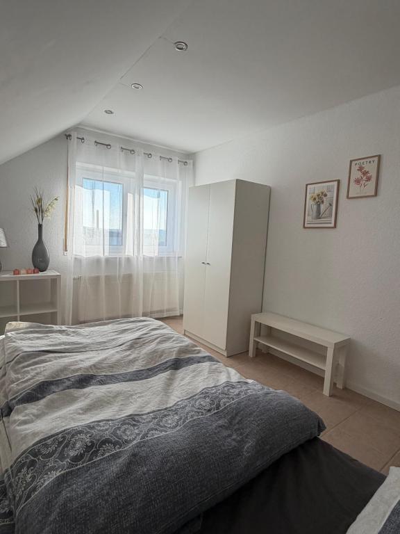a bedroom with a bed and a white cabinet at Ferienwohnung in Staufenberg- Treis in Staufenberg