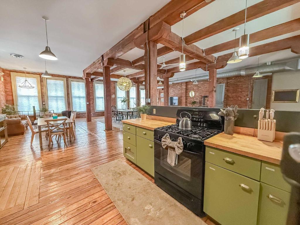 a large kitchen with a stove and a dining room at Loft 40 in Cleveland