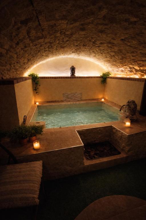 a swimming pool in a stone building with lights at Suite spa Romantique avec piscine privée cosy clim in Coligny