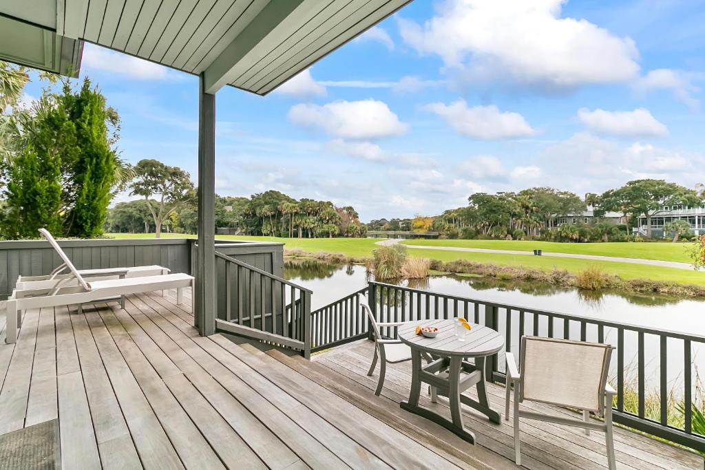a deck with a table and chairs and a river at 4956 Green Dolphin in Kiawah Island