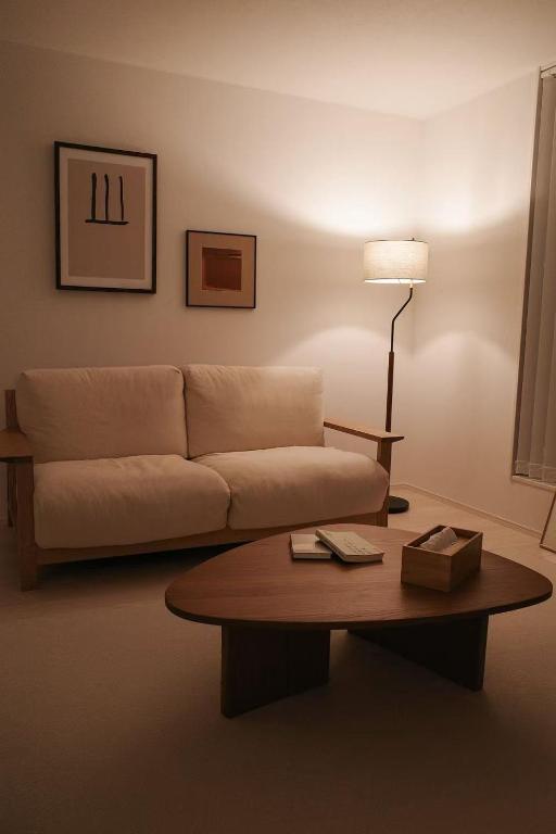a living room with a couch and a coffee table at Tokyo stay 365 in Tokyo