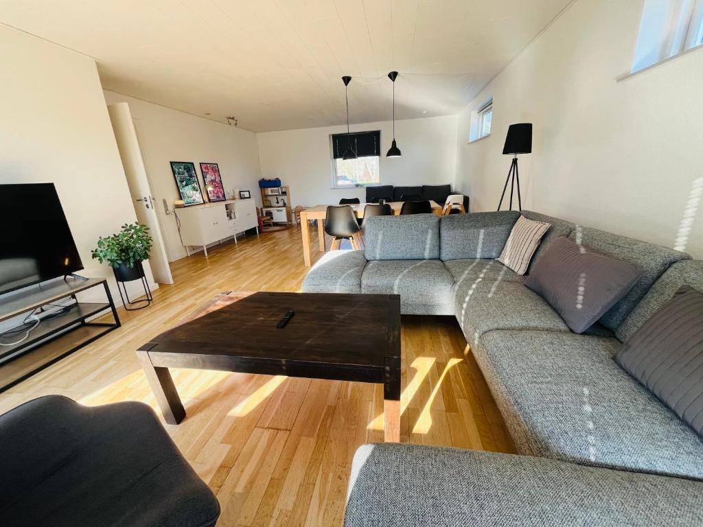 a living room with a couch and a table at Entire Home in Billund Center in Billund